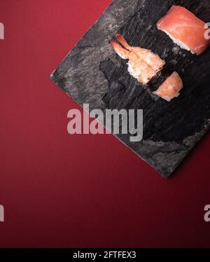Sushi on black stone plate. Stock Photo