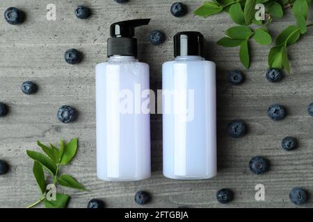 Shower gels and blueberry on gray textured background Stock Photo