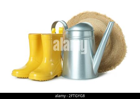 Watering can, rubber boots and straw hat isolated on white background Stock Photo