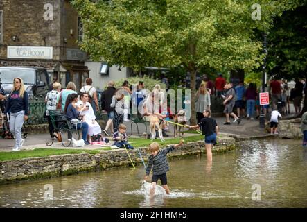 Scenes in the Cotswold village of Bourton-on-the-Water which is experiencing unprecedented visitor numbers during the Coronavirus pandemic Stock Photo