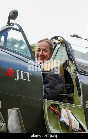 Carolyn Grace, female pilot and owner of Supermarine Spitfire Second World War fighter plane. In cockpit. World War Two Spitfire TIX ML407 airplane Stock Photo