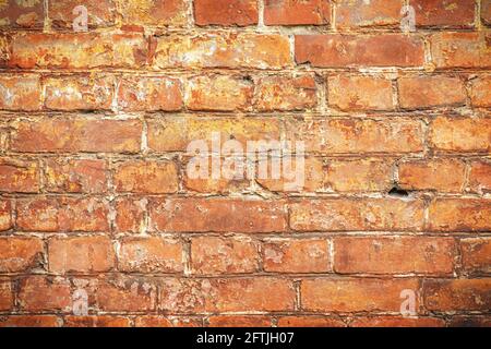 Weathered stained old brick wall background. Red old brick wall. Stock Photo