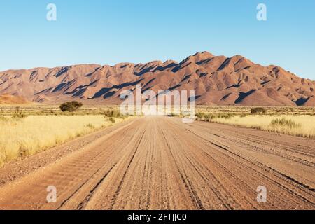 Gravel road and beautiful landscape with sunset sky Stock Photo