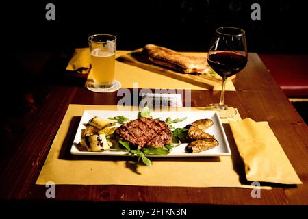 hamburger served on a plate with a side of vegetables Stock Photo