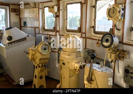 Navigational bridge on abandoned vessel. Old derelict ship wheelhouse. Ship's control device. Russian words: Ahead/Astern, full, half, slow, dead slow Stock Photo