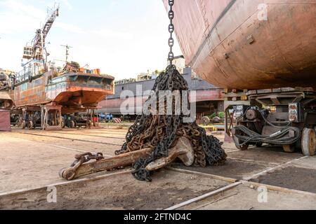 Anchor with chain ashore on ship repairing yard. Stock Photo