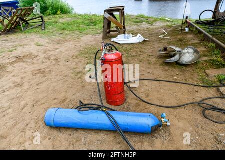 Cylinder with gas for welding works on ship repairing yard - hot work. Acetylene and oxygen. Stock Photo