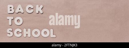 Inscription BACK TO SCHOOL of wooden letters on craft background. The concept of the importance of education. Copy space Stock Photo