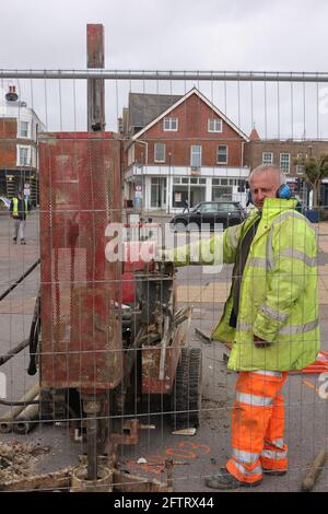 Operator manages a machine testing the soil stability during a geological survey. Stock Photo
