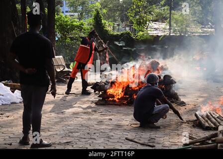 Guwahati, India. May 21, 2021: Municipality workers performing last rites of a person, who died from COVID-10 coronavirus disease, at a crematorium in Guwahati. Credit: David Talukdar/ZUMA Wire/Alamy Live News Stock Photo