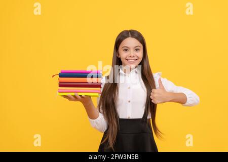 book store. educational childrens literature. overwhelmed intellectual child. thumb up. Stock Photo