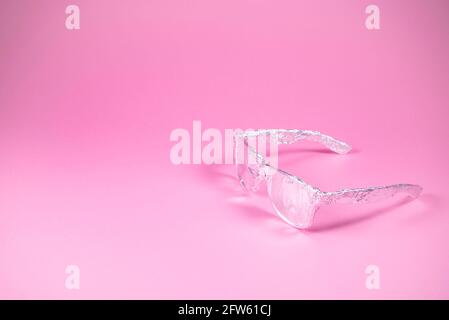 Retro sunglasses wrapped in aluminium foil on trendy pink background. Futuristic look. Minimal abstract summer concept. With copy space. Stock Photo