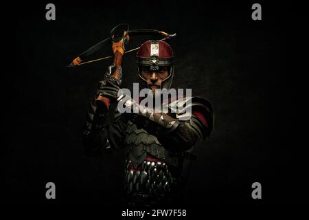 Portrait of a medieval fighter holding a crossbow in his hands Stock Photo