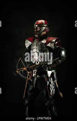 Portrait of a medieval fighter holding a crossbow in his hands Stock Photo