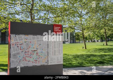 Pittsburgh, Pennsylvania, USA- May 13, 2021: Carnegie Mellon University map and sign with campus in the background Stock Photo