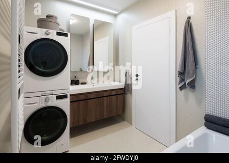 Interior of contemporary bathroom with washing machine and dryer Stock Photo