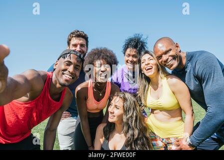 Group of runners taking a selfie in a park. Happy and smiling. Stock Photo