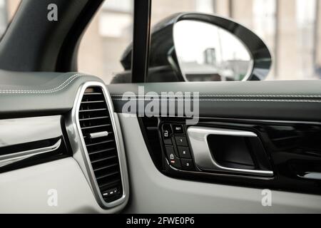 Dark car interior - ventilation system, door handle lock, side rearview mirror Stock Photo