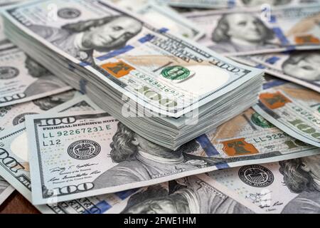 Stack of one hundred dollars notes on dollars background Stock Photo