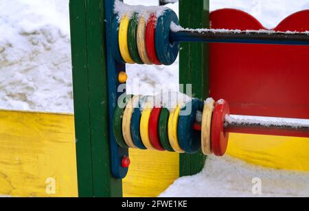 abacus under the snow on the playground. Stock Photo