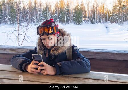 Young teenage man using smartphone taking a selfie for his profile. Stock Photo