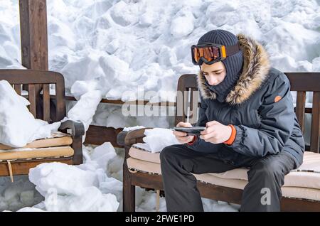 Young teenage man using smartphone for video call Stock Photo