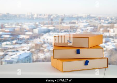 Gift in a yellow box. Three yellow boxes on a natural light background. Horizontally with copy space.. Stock Photo