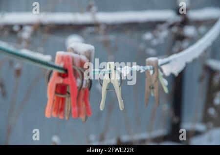 clothespins on a rope under the snow. Stock Photo