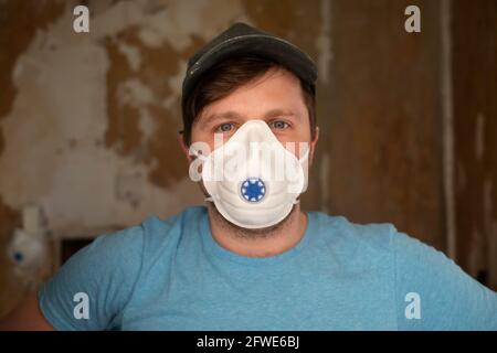 Young male builder in a protective respirator Stock Photo