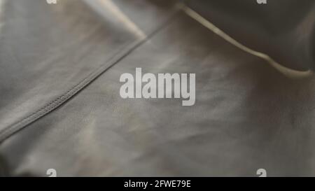 soft gray leather with seam under warm sun light, wide photo Stock Photo