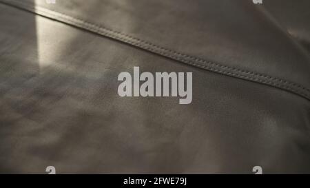 soft gray leather with seam under warm sun light, wide photo Stock Photo