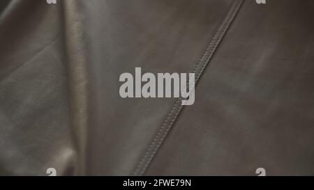 soft gray leather with seam under warm sun light, wide photo Stock Photo