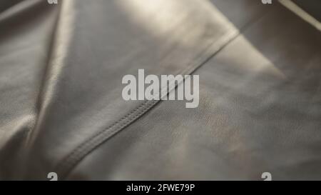 soft gray leather with seam under warm sun light, wide photo Stock Photo