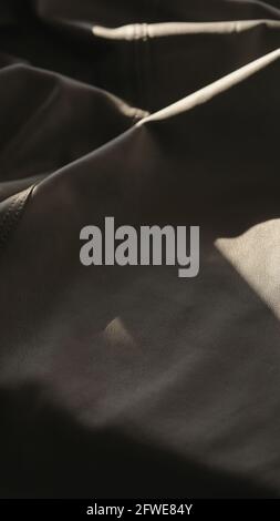 soft gray leather with seam under warm sun light, wide photo Stock Photo