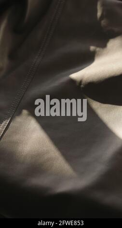 soft gray leather with seam under warm sun light, wide photo Stock Photo