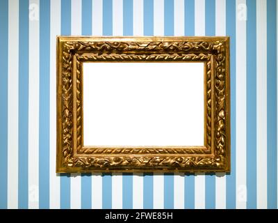 wide baroque wooden picture frame with cutout canvas on blue striped wall Stock Photo