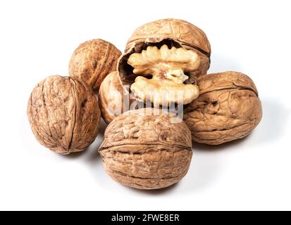 several whole and shelled walnuts closeup on white background Stock Photo