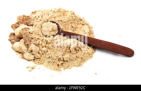 wooden spoon on pile of dried ginger roots and powder on white background Stock Photo