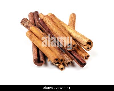 pile of chinese cinnamon (Cassia) sticks closeup on white background Stock Photo
