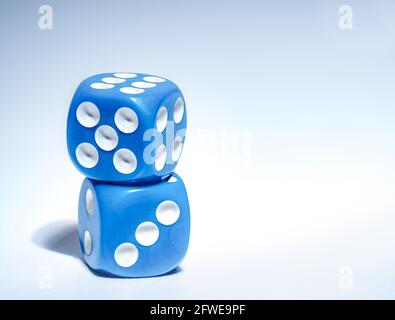 Two blue dices one on top of the other closeup Stock Photo