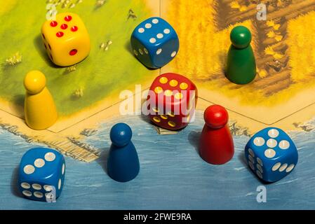 Several colorful dices and chips on game board Stock Photo
