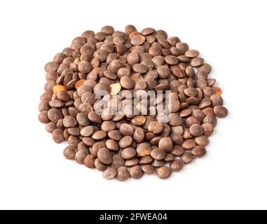 handful of brown unhulled red lentils closeup on white background Stock Photo