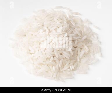pile of raw long-grain polished rice closeup on white background