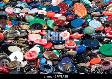 many different used buttons on surface of table closeup Stock Photo