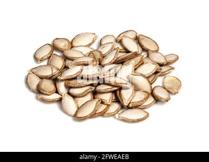 pile of unhusked Pumpkin seeds closeup on white background Stock Photo