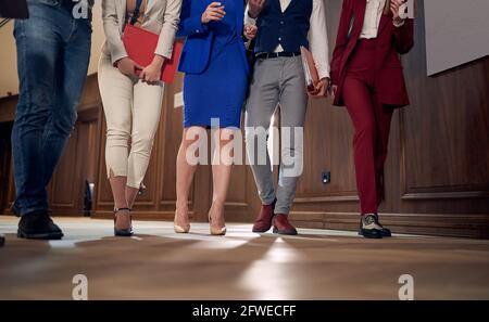 cropped image of businesspeople walking through hallway Stock Photo