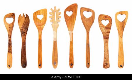 Various heart shape of wooden cooking utensils. Wooden spoons and wooden spatula isolate on white background. Stock Photo