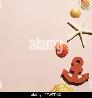 Starfish, straw hat, anchor, seashell on pink background. summer marine decoration. flat lay, top view, copy space Stock Photo