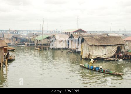 A woman paddling through makoko waterfront, Lagos, Nigeria. Stock Photo
