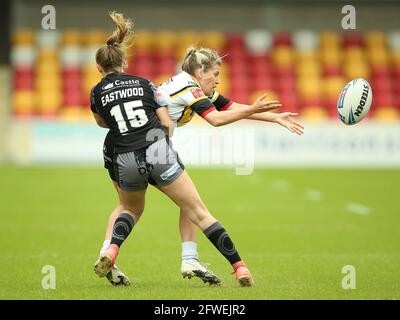 York City Knights' Bethany Lambert (right) is tackled by Castleford Tigers' Lucy Eastwood during the Women's Challenge Cup semi final match at the LNER Stadium, York. Picture date: Saturday May 22, 2021. Stock Photo